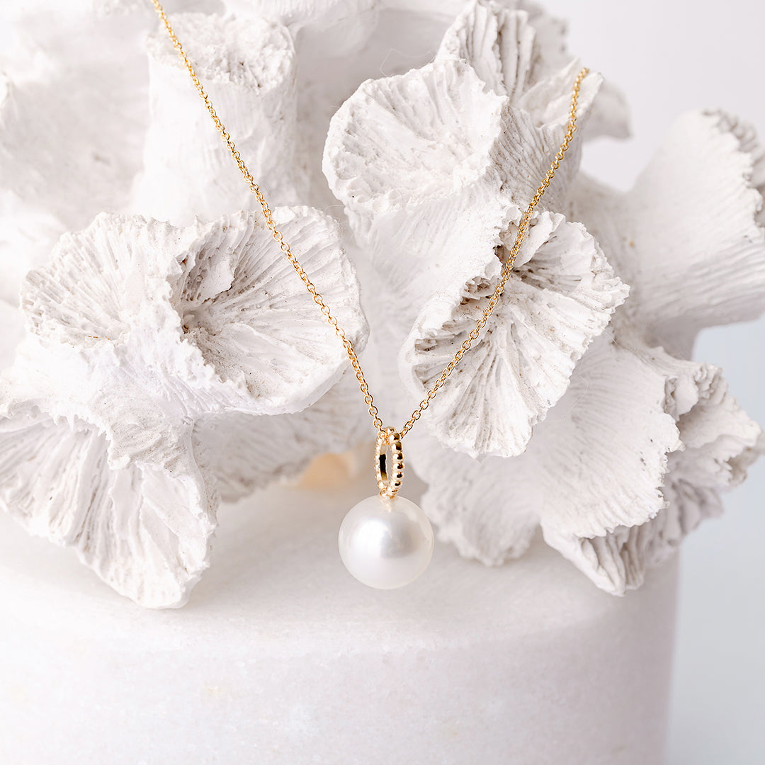 Yellow Gold Pearl Pendant on coral