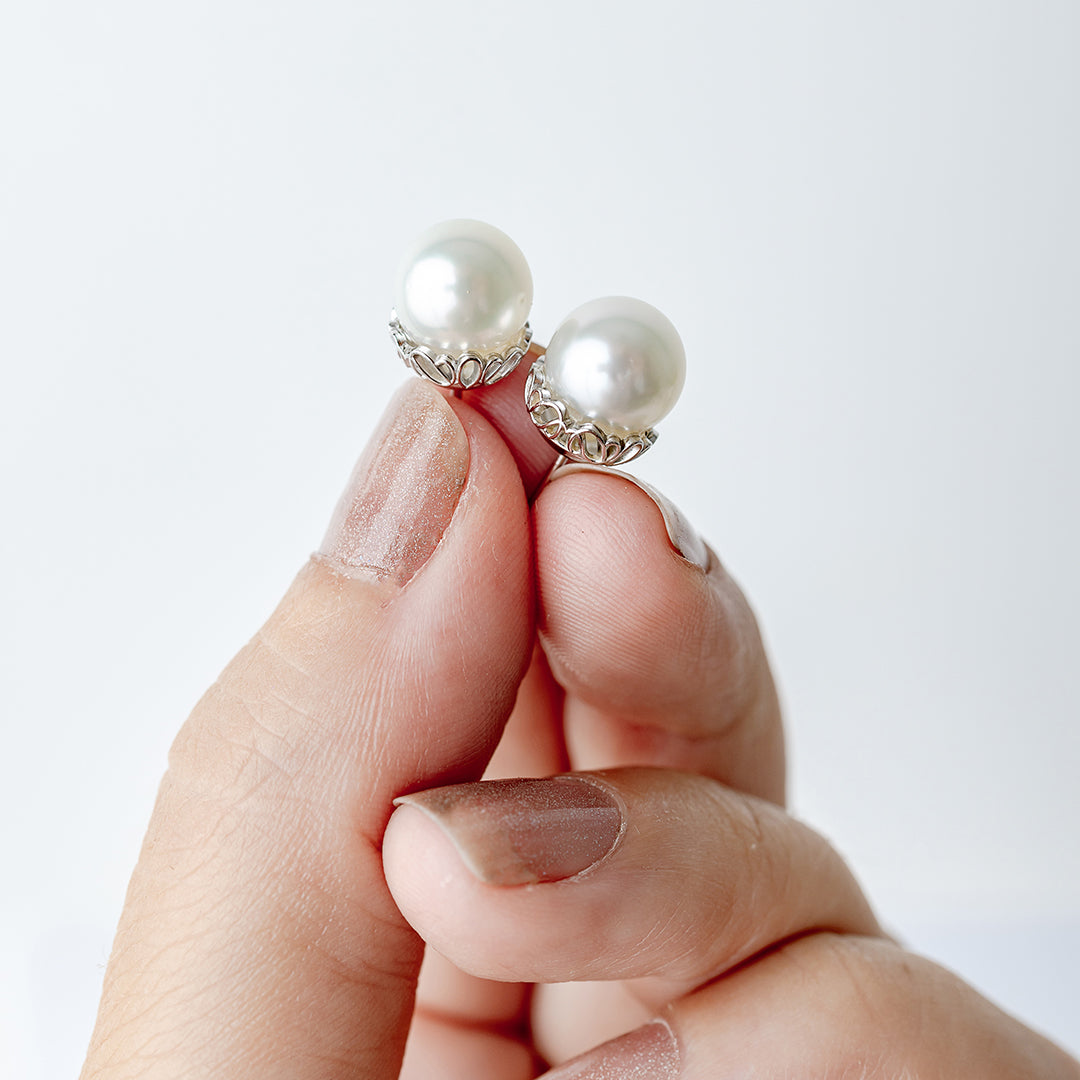 White Gold Filagree Pearl Studs in hand